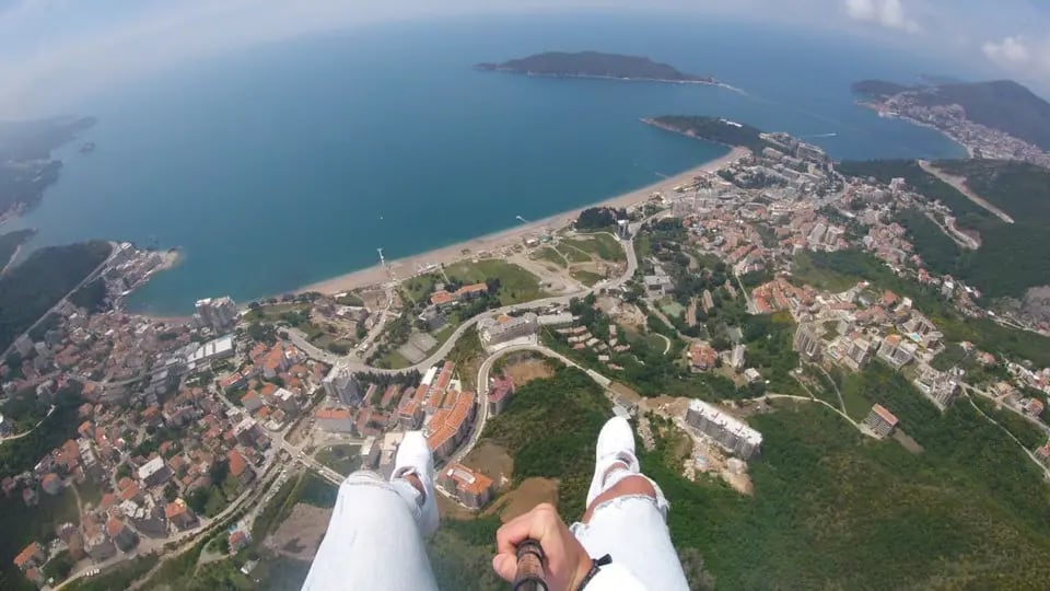 Easy coastal paragliding mood near Becici with open sea and shoreline light