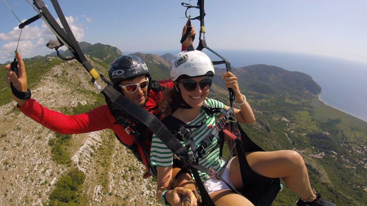 Tandem paragliding pair ready for a Petrovac or Bar scenic-fit inquiry