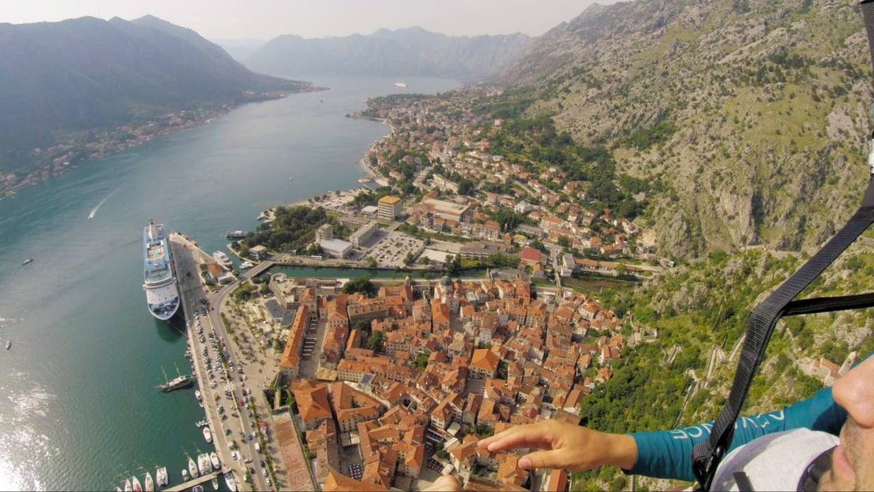 Bay of Kotor paragliding view used for bounded scenic comparison, not as a universal best-place claim