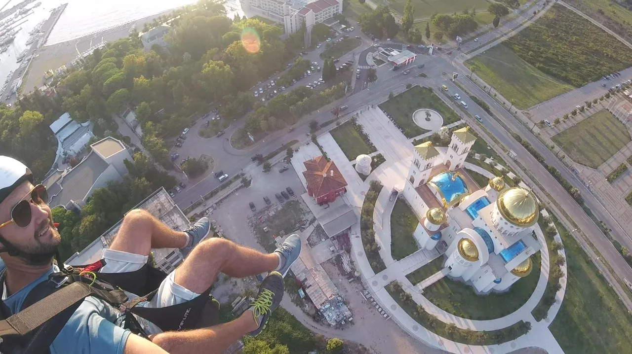 Paraglider over Bar city with the Adriatic and mountain line in view