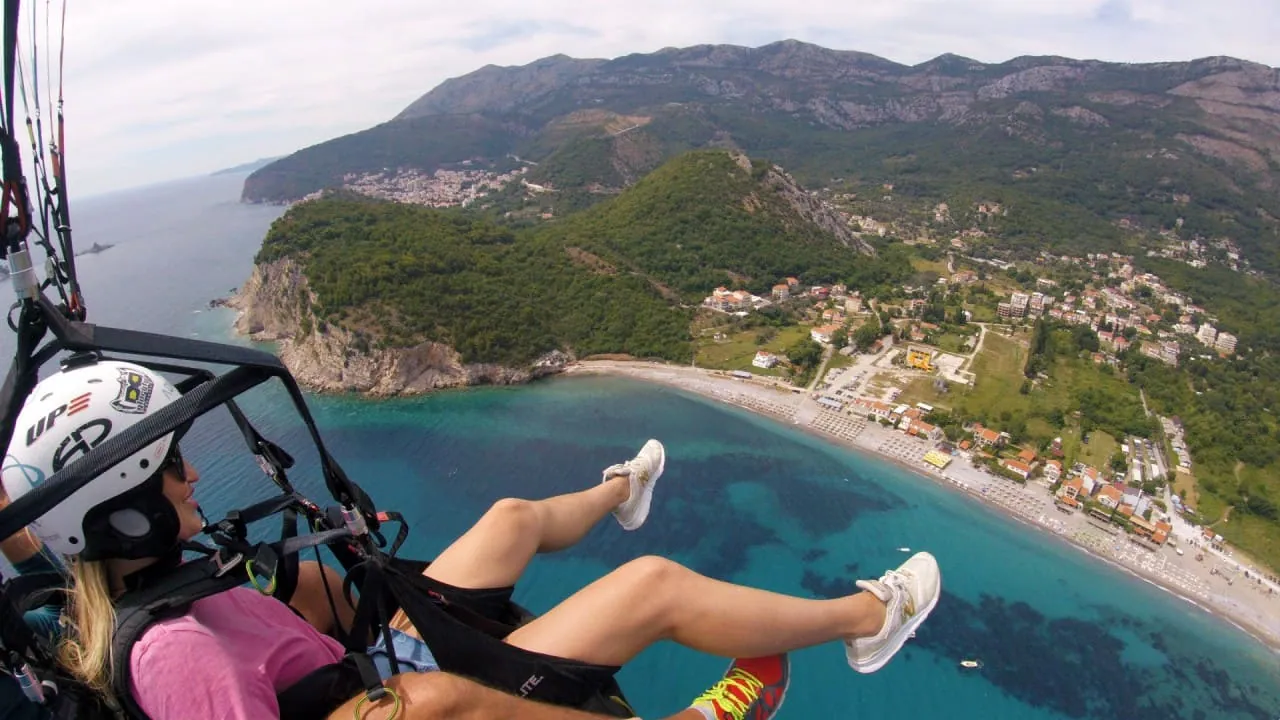 Paragliding view above Buljarica with the Petrovac coast and open Adriatic below